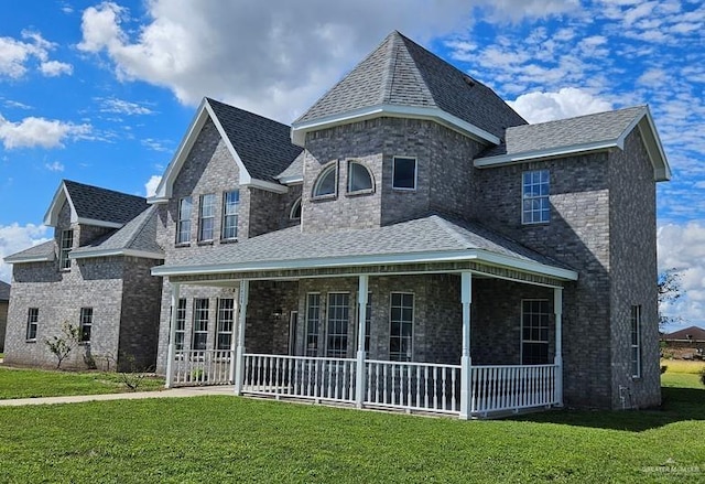 view of front of house featuring a porch and a front lawn