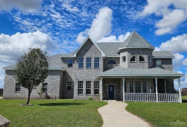 27406 S Kelly Ct, La Feria, TX 78559 - view of front facade featuring a front lawn, roof with shingles, and brick siding