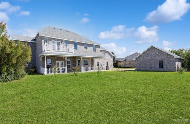 27406 S Kelly Ct, La Feria, TX 78559 - rear view of property featuring a yard, brick siding, french doors, and a balcony