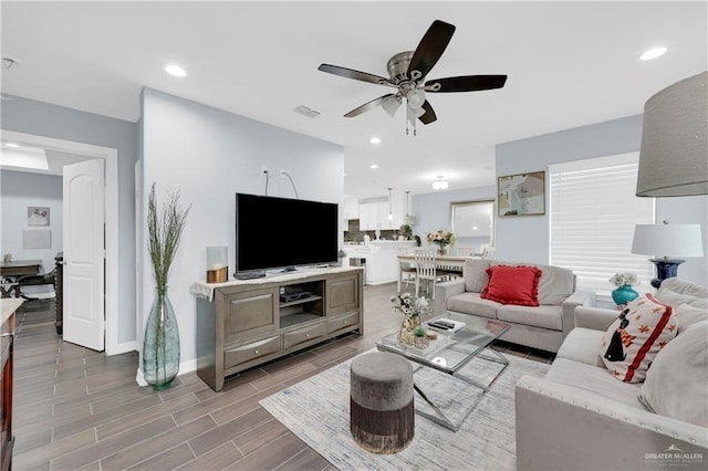 living area featuring visible vents, baseboards, a ceiling fan, wood tiled floor, and recessed lighting