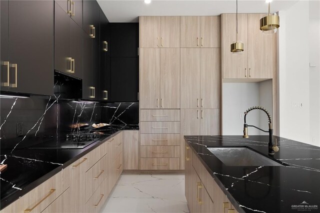 kitchen featuring dark stone countertops, decorative backsplash, light brown cabinetry, and sink