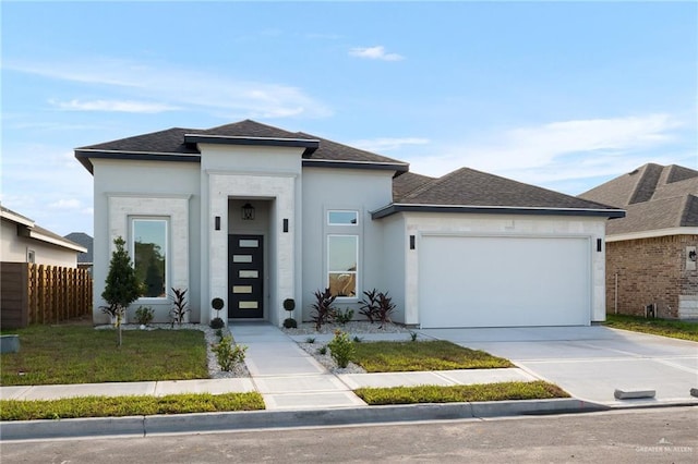 prairie-style house featuring a garage and a front yard