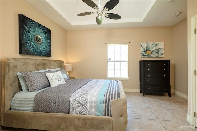 24162 N Tamm Ln, Harlingen, TX 78552 - bedroom featuring a raised ceiling, baseboards, ceiling fan, and light tile patterned flooring