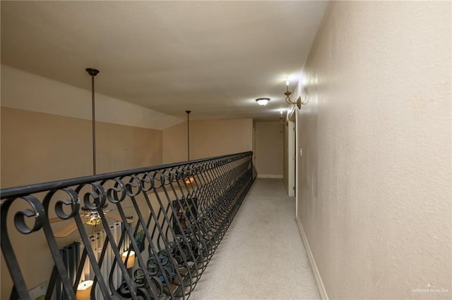 24162 N Tamm Ln, Harlingen, TX 78552 - hall featuring baseboards, light carpet, a textured wall, and vaulted ceiling