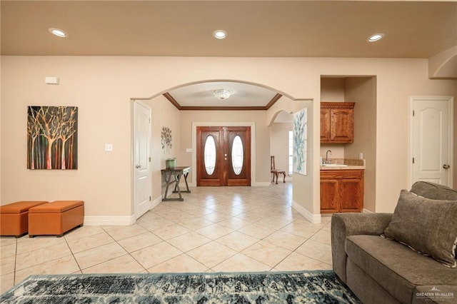 24162 N Tamm Ln, Harlingen, TX 78552 - foyer entrance featuring arched walkways, light tile patterned floors, baseboards, ornamental molding, and recessed lighting