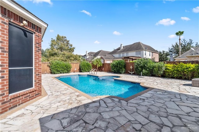 view of swimming pool with an in ground hot tub and a patio