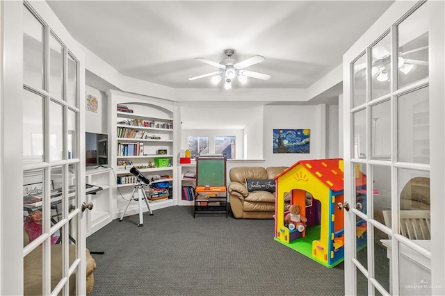 rec room featuring dark colored carpet, french doors, and ceiling fan