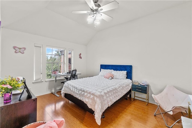 bedroom featuring hardwood / wood-style flooring, ceiling fan, and vaulted ceiling