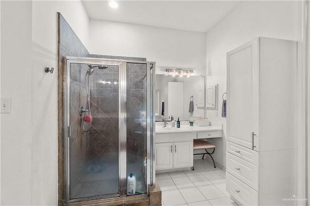 bathroom with tile patterned floors, vanity, and a shower with shower door