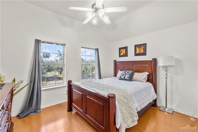 bedroom featuring ceiling fan, vaulted ceiling, and light hardwood / wood-style flooring