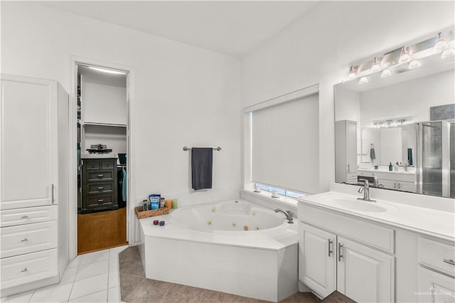 bathroom featuring tile patterned floors, vanity, and plus walk in shower