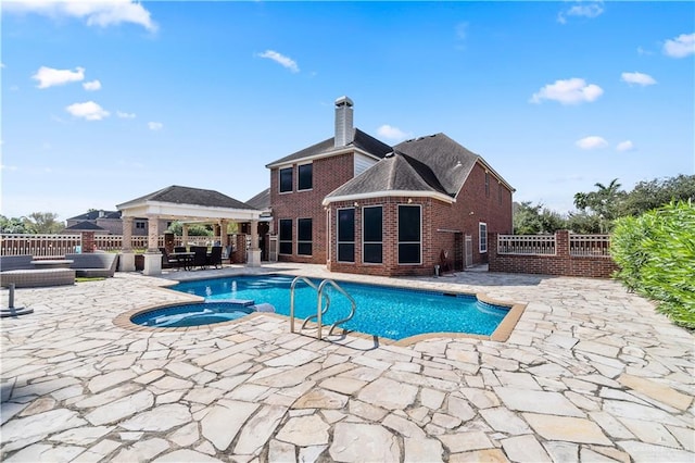 view of swimming pool with a gazebo, an outdoor hangout area, an in ground hot tub, and a patio