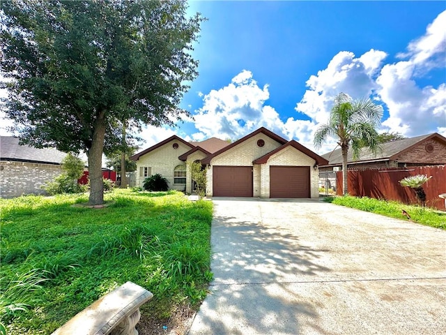 view of front of home with a front yard and a garage