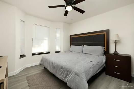 bedroom featuring hardwood / wood-style flooring and ceiling fan