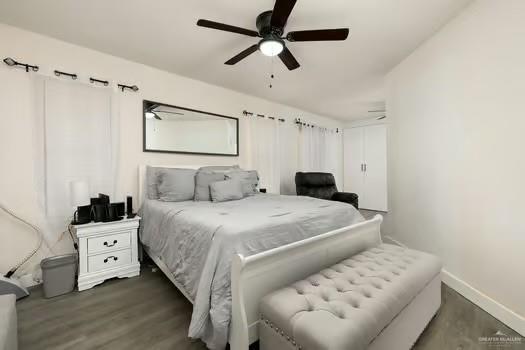 bedroom featuring ceiling fan and dark wood-type flooring