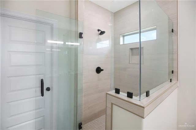 bathroom with a shower with door