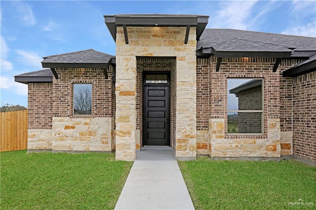 doorway to property with a yard