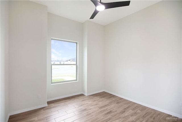 empty room featuring ceiling fan and light hardwood / wood-style floors