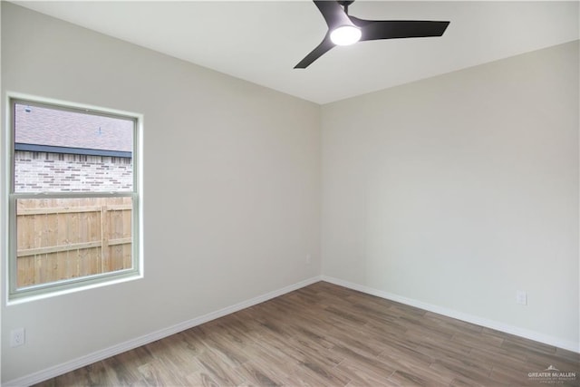 empty room featuring ceiling fan and hardwood / wood-style floors