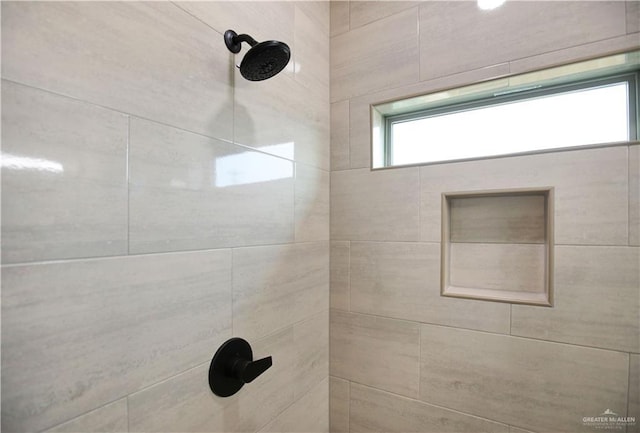 bathroom with a tile shower