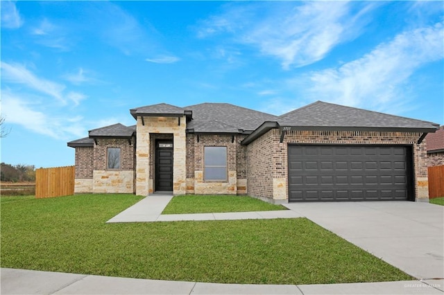 view of front of house featuring a garage and a front lawn