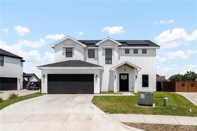 1405 Jocelyn Cir, Harlingen, TX 78552 - modern farmhouse style home with board and batten siding, fence, roof mounted solar panels, driveway, and a front yard