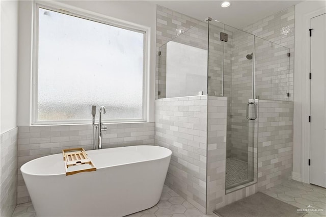 1405 Jocelyn Cir, Harlingen, TX 78552 - full bath with tile walls, a stall shower, and plenty of natural light