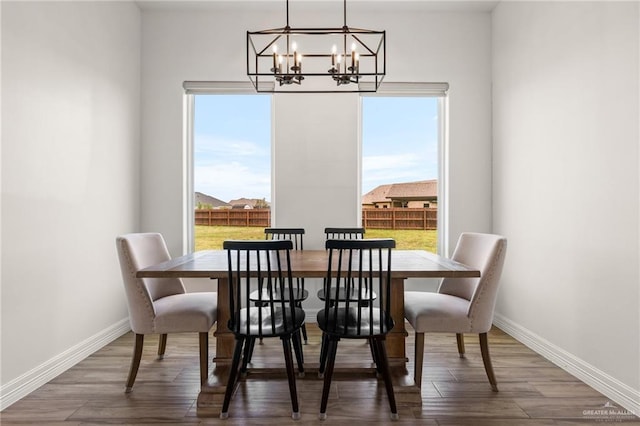 1405 Jocelyn Cir, Harlingen, TX 78552 - dining room with wood finished floors, a notable chandelier, and baseboards