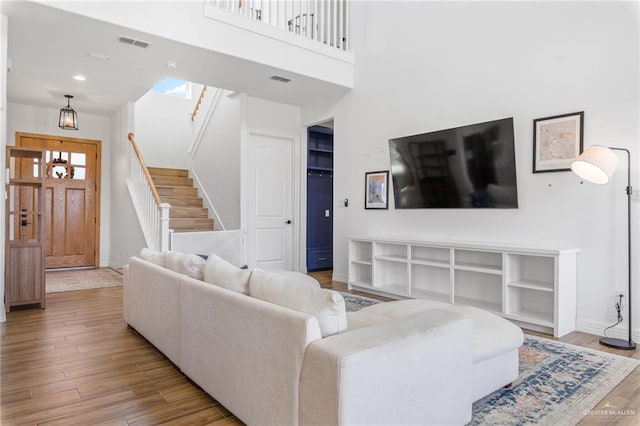 1405 Jocelyn Cir, Harlingen, TX 78552 - living area featuring stairway, wood finished floors, visible vents, and baseboards