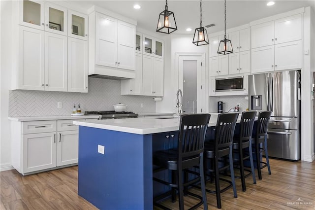 1405 Jocelyn Cir, Harlingen, TX 78552 - kitchen with built in microwave, recessed lighting, a sink, a kitchen island with sink, and stainless steel refrigerator with ice dispenser