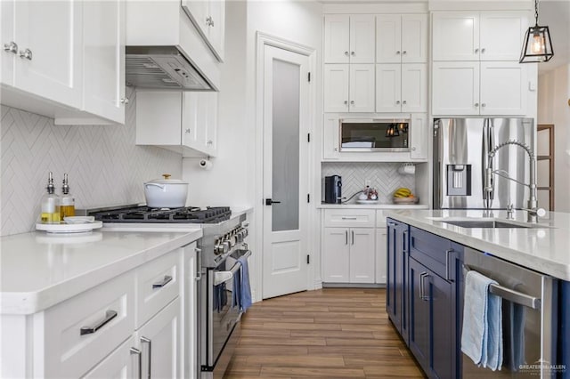 1405 Jocelyn Cir, Harlingen, TX 78552 - kitchen with white cabinets, stainless steel appliances, and decorative backsplash