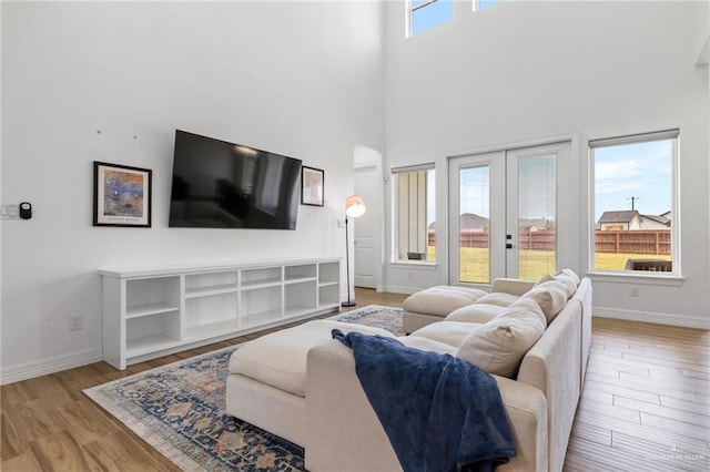 1405 Jocelyn Cir, Harlingen, TX 78552 - living area featuring baseboards, light wood-style floors, and a towering ceiling