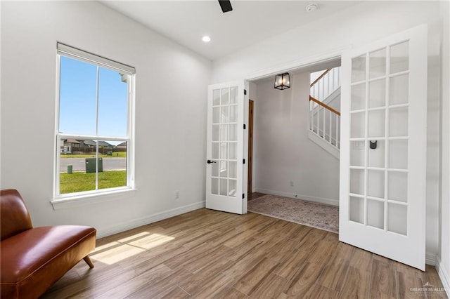 1405 Jocelyn Cir, Harlingen, TX 78552 - unfurnished room featuring wood finished floors, french doors, stairs, and baseboards