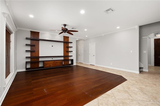 unfurnished living room with ornamental molding, ceiling fan, and light tile patterned flooring