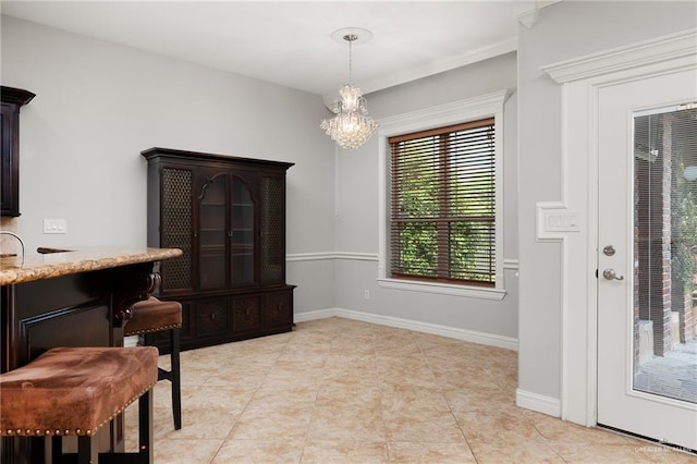 interior space featuring light tile patterned floors and a chandelier