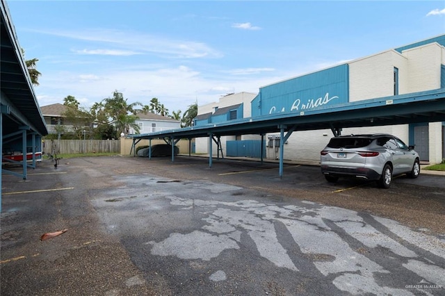 view of parking / parking lot featuring a carport