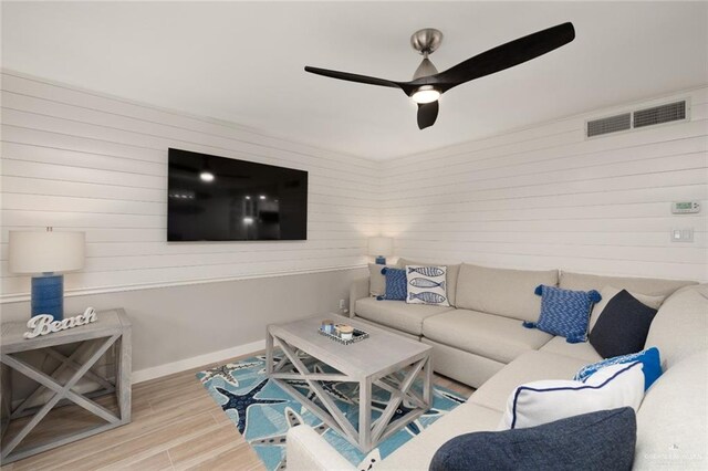 living room featuring ceiling fan and light wood-type flooring