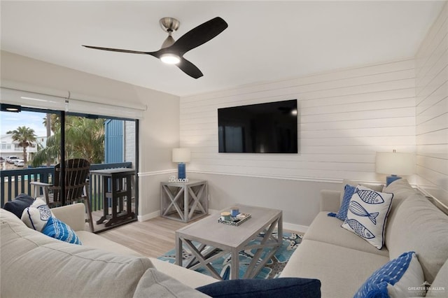 living room with light wood-type flooring and ceiling fan