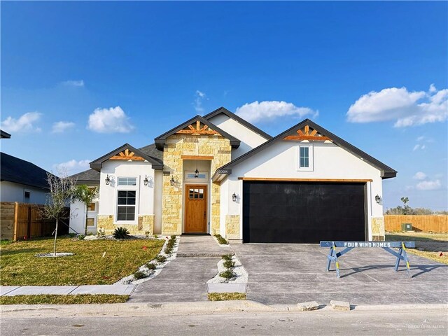 view of front of home with a yard and a garage