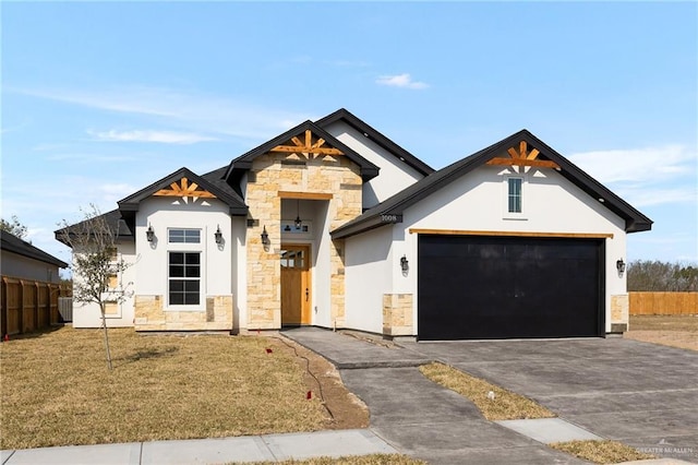 modern farmhouse style home with stucco siding, an attached garage, fence, stone siding, and driveway