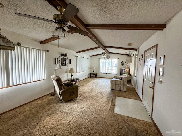 living room featuring vaulted ceiling with beams, ceiling fan, a textured ceiling, and carpet