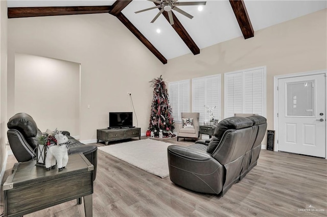 living room featuring high vaulted ceiling, ceiling fan, beamed ceiling, and light wood finished floors