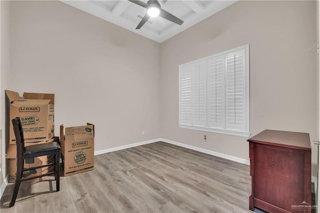 interior space with ceiling fan, beamed ceiling, baseboards, and wood finished floors