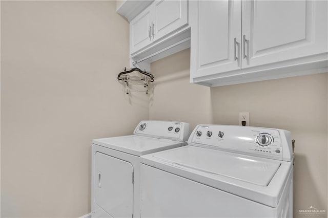 washroom featuring cabinet space and washing machine and dryer