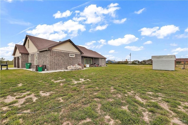 view of property exterior featuring brick siding and a lawn