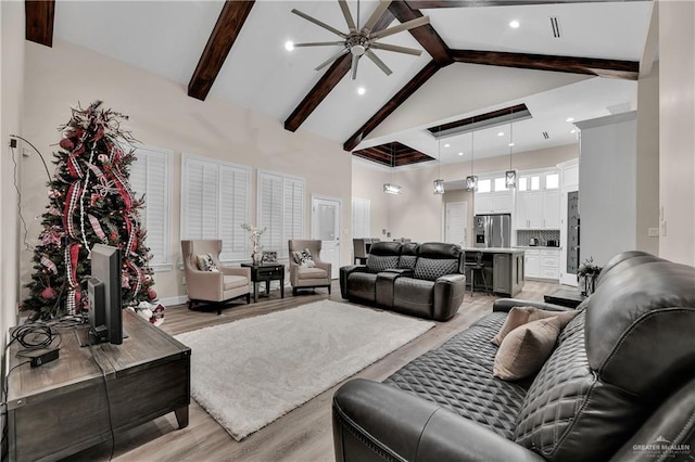 living area with high vaulted ceiling, beam ceiling, light wood-style flooring, and recessed lighting