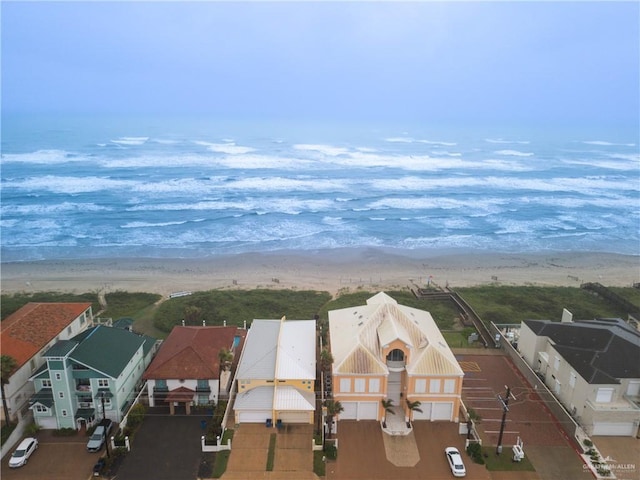 drone / aerial view featuring a water view and a beach view