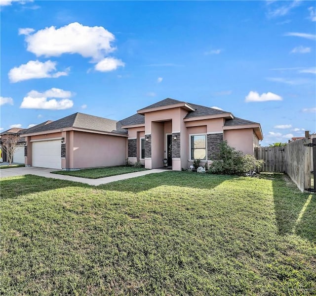 prairie-style home featuring fence, a front yard, stucco siding, stone siding, and an attached garage