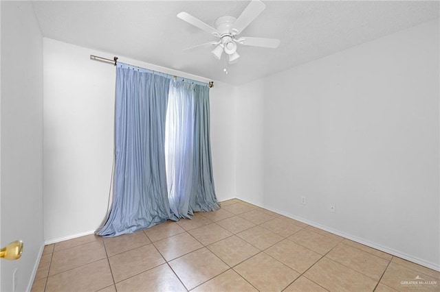 2706 E 28th St, Mission, TX 78574 - empty room with light tile patterned floors, ceiling fan, and baseboards