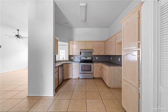 2706 E 28th St, Mission, TX 78574 - kitchen with stainless steel appliances, light brown cabinets, light tile patterned flooring, ceiling fan, and a towering ceiling
